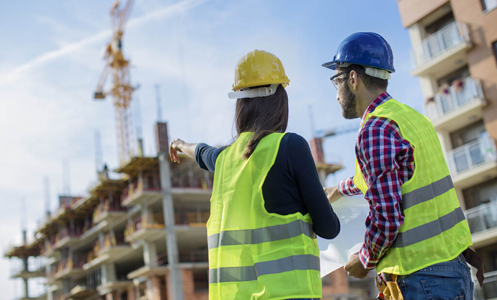 Two people on a construction site