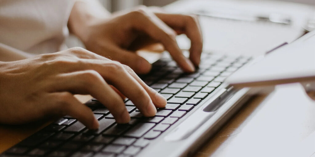 Male Hands Typing on a Wireless Computer Keyboard