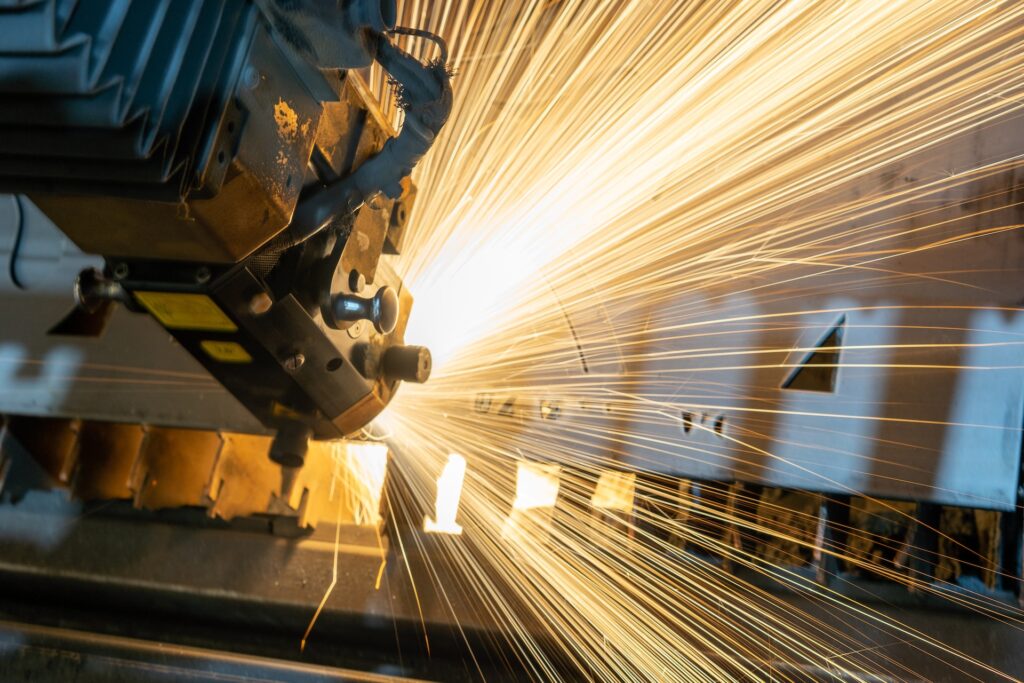 Manufacturing scene in a factory with large machinery and sparks flying